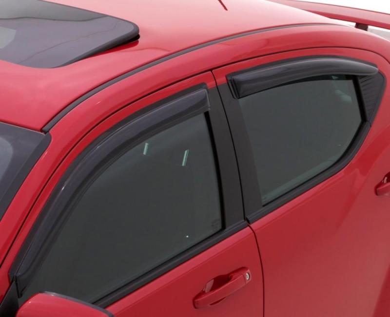 Red car with black roof rack using avs original ventvisor window deflectors for fresh air