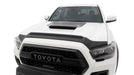 Front view of white toyota tacoma truck with avs aeroskin ii textured hood shield in black