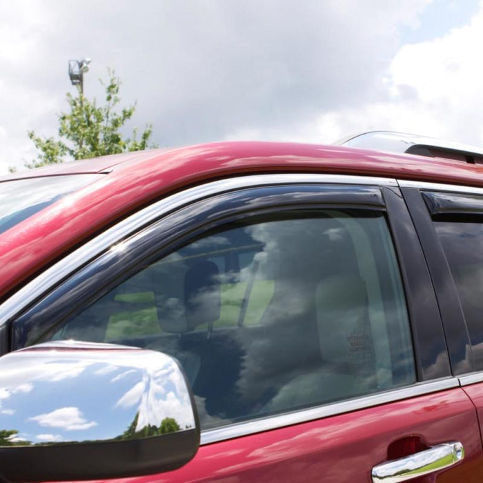 Red car with black roof rack next to avs 16-18 toyota tacoma double cab ventvisor in-channel front & rear window deflectors - smoke