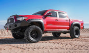 Red truck on dirt road with avs toyota tacoma double cab ventvisor in-channel front & rear window deflectors providing fresh air