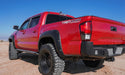 Red truck parked in desert featuring avs tacoma window deflectors for fresh air flow