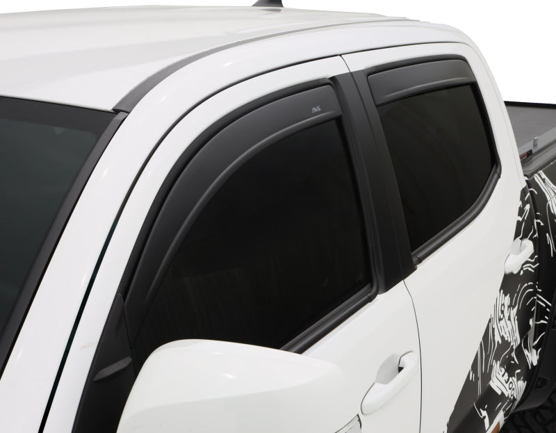 White truck with black and white decal featuring avs toyota tacoma window deflectors