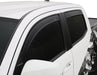 White truck with black and white decal featuring avs toyota tacoma window deflectors