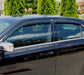 Black car parked in lot with avs original ventvisor window deflectors, allowing fresh air to flow