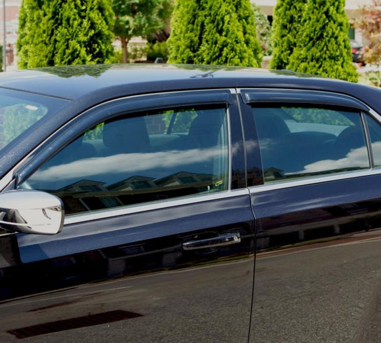 Black car parked in parking lot with avs original ventvisor window deflectors in smoke for fresh air