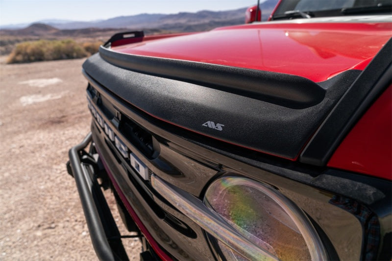 Red truck with headlight, avs aeroskin ii textured low profile hood shield - black