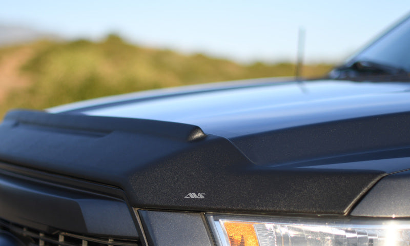 Front bumper of black ford with avs aeroskin ii textured low profile hood shield in black