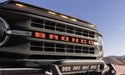 Black truck with red and orange logo featuring avs aeroskin lightshield hood protector