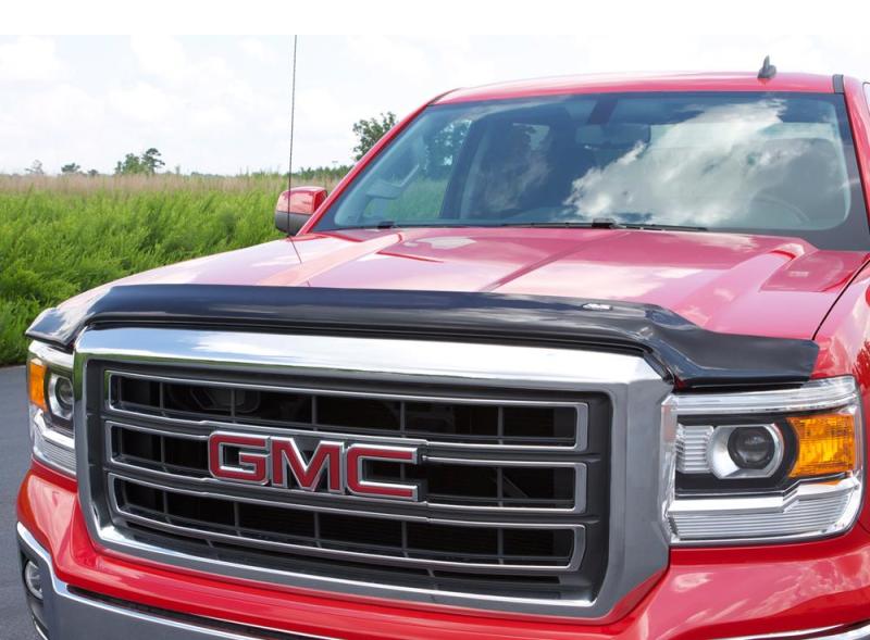 Red truck parked in parking lot with avs bugflector hood shield - car wash safe