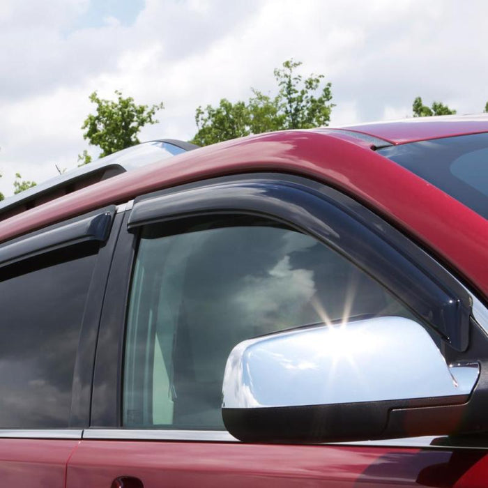 Red car with side mirror driving with avs original ventvisor window deflectors for fresh air