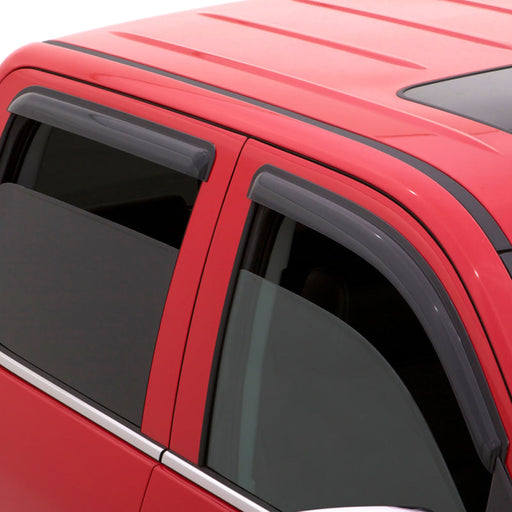 Red car with black roof rack showcasing avs 96-02 toyota 4runner ventvisor window deflectors - smoke