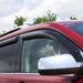 Red car with side mirror benefiting from avs original ventvisor window deflectors, providing fresh air in smoke color
