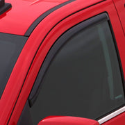 Red car with black roof featuring avs 97-06 jeep wrangler ventvisor in-channel window deflectors - smoke