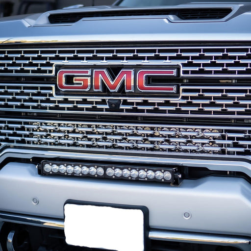 Close-up of gmc logo on truck grille with 30in grille led light bar kit by baja designs