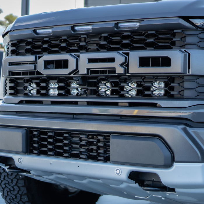 Baja designs 2021+ ford raptor squadron sport behind grille kit featuring front bumper grille