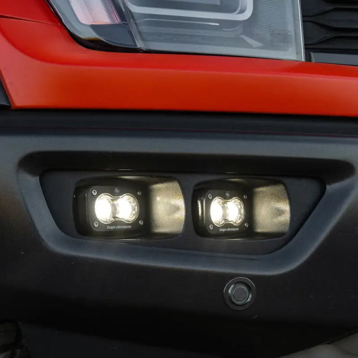 Red Ford Baja Designs Tundra S2 SAE OEM fog light bumper close-up.