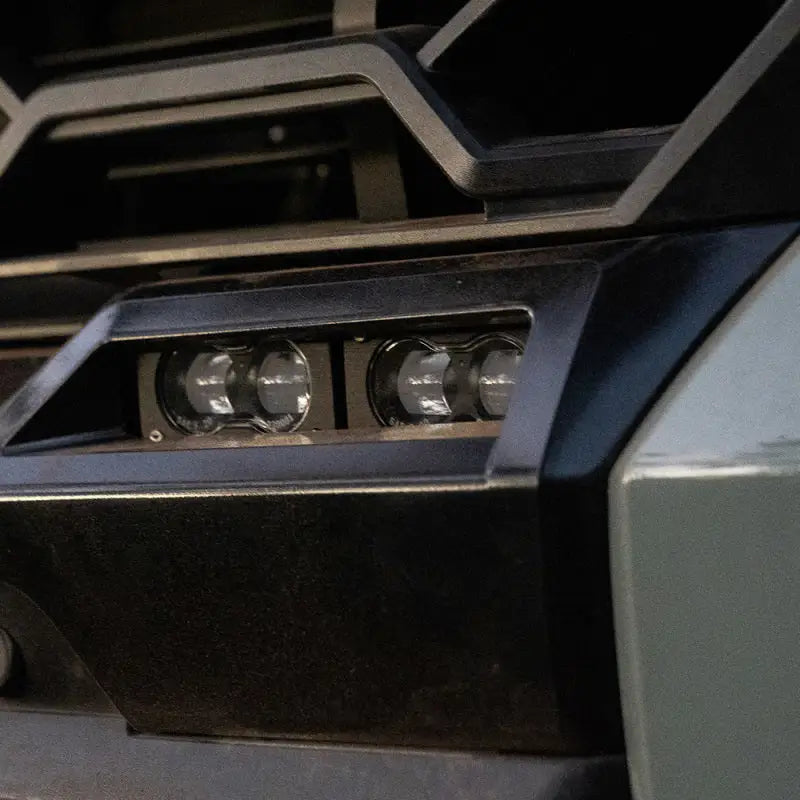 Baja Designs 2022+ Toyota Tundra S2 SAE OEM Fog Light Replacement Kit - Close-up of machine with two lights