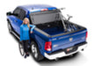 Man in blue shirt standing next to blue truck with bakflip mx4 matte finish installed