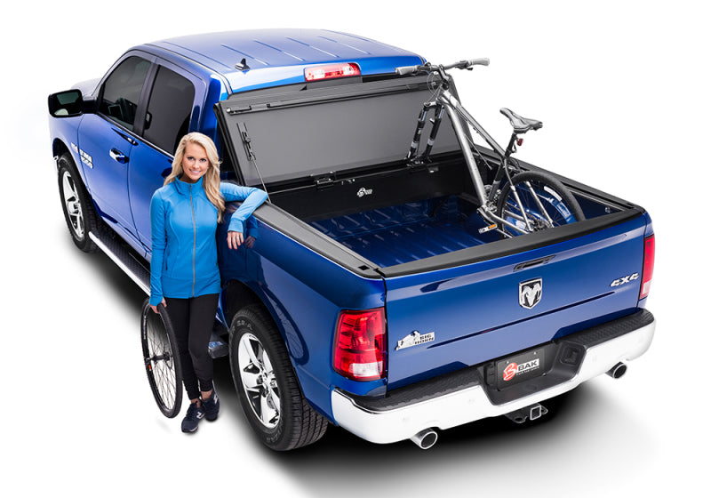 Woman standing next to truck with bike rack - bakflip mx4 matte finish installation