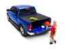 Woman standing next to truck with bakflip mx4 matte finish bed cover