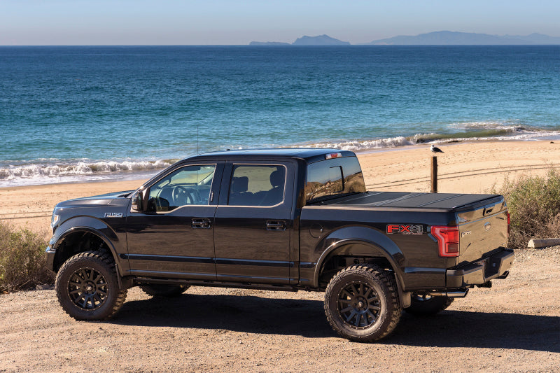 Black truck parked on beach - bak 04-14 ford f-150 6ft 6in bed bakflip mx4 matte finish
