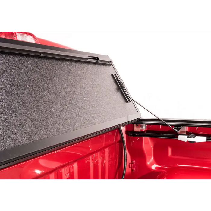 BAK 05-15 Toyota Tacoma 5ft Bed BAKFlip G2 with open rear window and closed door