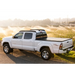 White truck parked on dirt road with BAK 05-15 Toyota Tacoma 6ft Bed BAKFlip G2 installed.