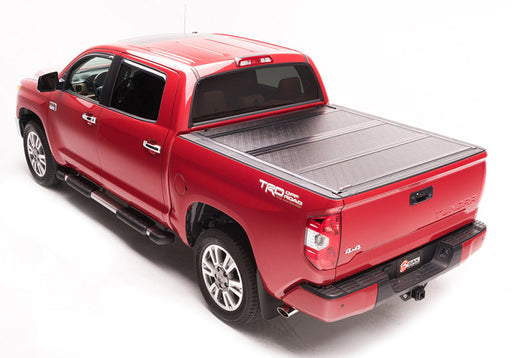 Red toyota tundra truck with black bed cover - bakflip g2 storage solution