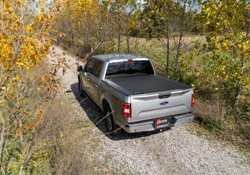 Toyota tundra revolver x4s truck bed cover parked on dirt road in woods