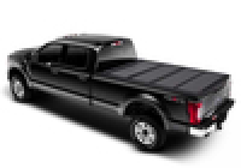 Black toy car with red tail on display next to bak 08-16 ford super duty 6ft 9in bed bakflip mx4 matte finish