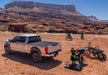 Ford super duty revolver x4s bed cover with truck in desert and bikers