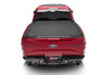 Red ford super duty revolver x4s bed cover featured on a red car’s rear