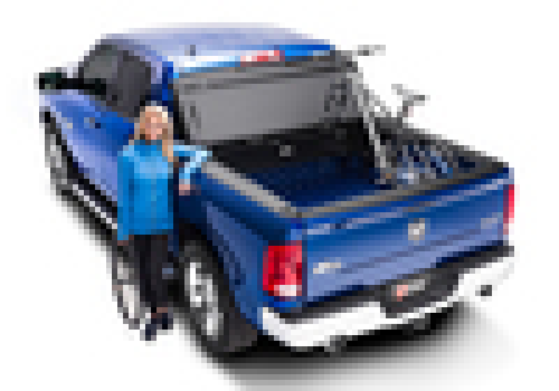 Man standing next to blue truck - bakflip mx4 matte finish for dodge ram 1500 - installation instructions