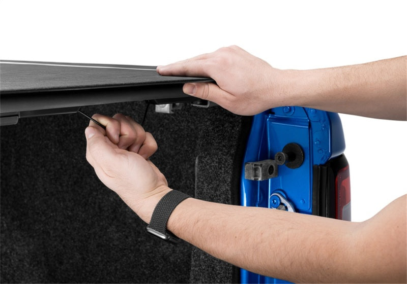 Man opening door to reveal blue door on bak 6ft 4in truck bed cover