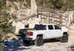 White chevy silverado truck driving on dirt road - bakflip g2 installation for 5ft 8in bed