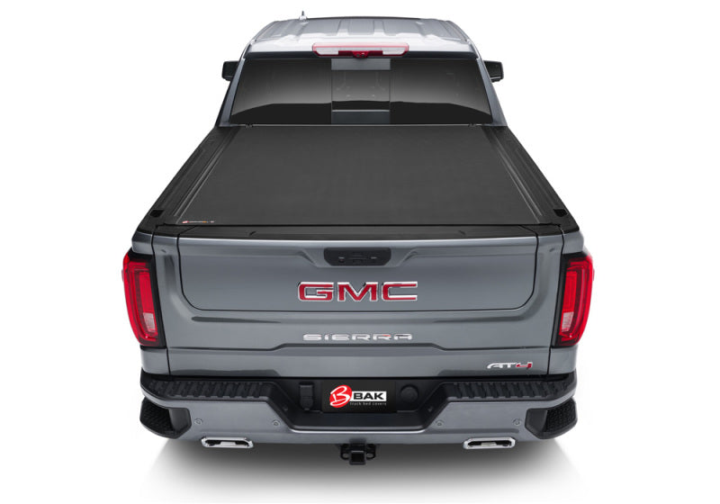 Rear view of a gmc truck with bak 2014-18 chevy silverado/gm sierra/2019 legacy revolver x4s bed cover