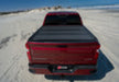 Red car driving on desert road, showcasing bakflip mx4 matte finish on chevy colorado/gmc canyon truck bed