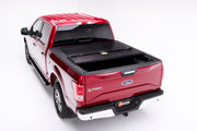 Red bakflip f1 truck bed cover for 15-20 ford f-150 5ft 6in bed with installation instructions displayed