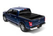 Toy truck with a black bed displayed on bakflip fibermax for ford f-150 5ft 6in bed