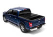 Toy truck with black top and blue bed displayed in bak 15-20 ford f-150 5ft 6in bed bakflip g2 product