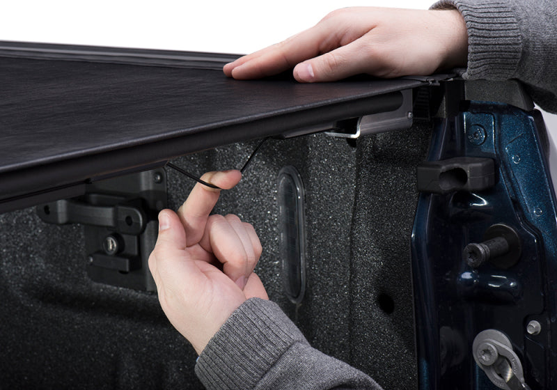 Man installing skateboard in bak ford f-150 revolver x2 truck bed