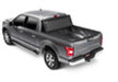 Black toy car with red light on top displayed on bak 15-20 ford f-150 6ft 6in bed bakflip mx4 matte