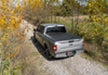 Ford f-150 revolver x4s bed cover driving down dirt road