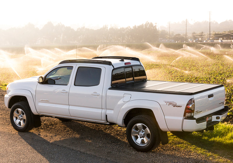 White truck parked on dirt road, bak 16-20 nissan titan 5ft 6in bed bakflip g2