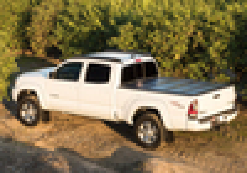 White truck parked on dirt road with bak 16-20 nissan titan 5ft 6in bed bakflip g2