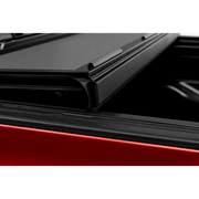 Red car rear window view on BAK 16-20 Toyota Tacoma 5ft Bed BAKFlip MX4 Matte Finish.