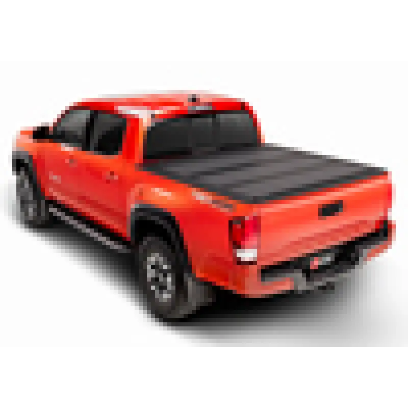 Red truck with black bed cover on BAKFlip MX4 for Toyota Tacoma.