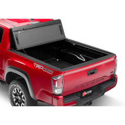 Red truck with bed cover open on BAK 16-20 Toyota Tacoma 6ft Bed BAKFlip MX4 Matte Finish.