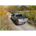 Toyota Tacoma Revolver X4s bed cover on truck parked dirt road.