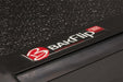 Black ford super duty truck tonneau cover with red and white logo